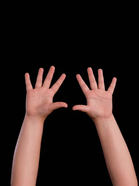 Handen omhoog van jongen geïsoleerd op zwarte achtergrond — Stockfoto