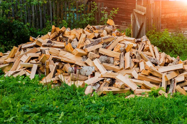 chopped wood near a village house on the street