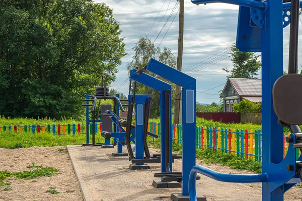 outdoor sports ground with blue exercise equipment