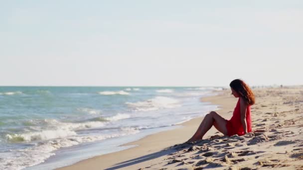 Young Girl Sits Alone Seashore Young Woman Red Dress Sitting — Stock Video