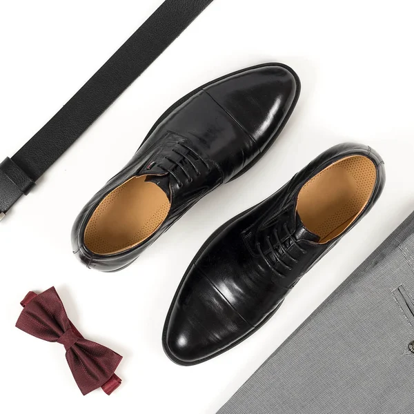 Modern insan aksesuarları, yakın çekim. Bordeaux papyon, deri ayakkabı, kemer beyaz arka plan üzerinde. Eşyası izole üzerinde beyaz arka plan resmi stil kümesi