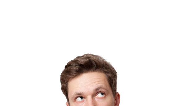 Portrait of a young handsome man looking up. Isolated on white background