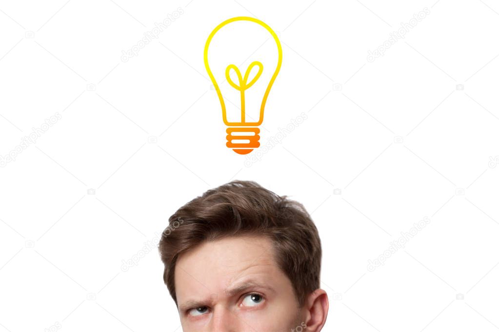 Young man with thoughtful expression and light bulb over his hea