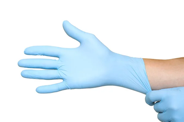 Doctor putting on protective blue gloves isolated on yellow back — Stock Photo, Image