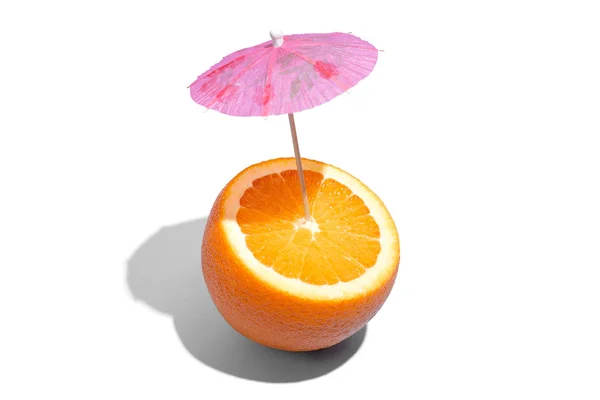 Fresh juicy orange with a cocktail umbrella isolated on white ba