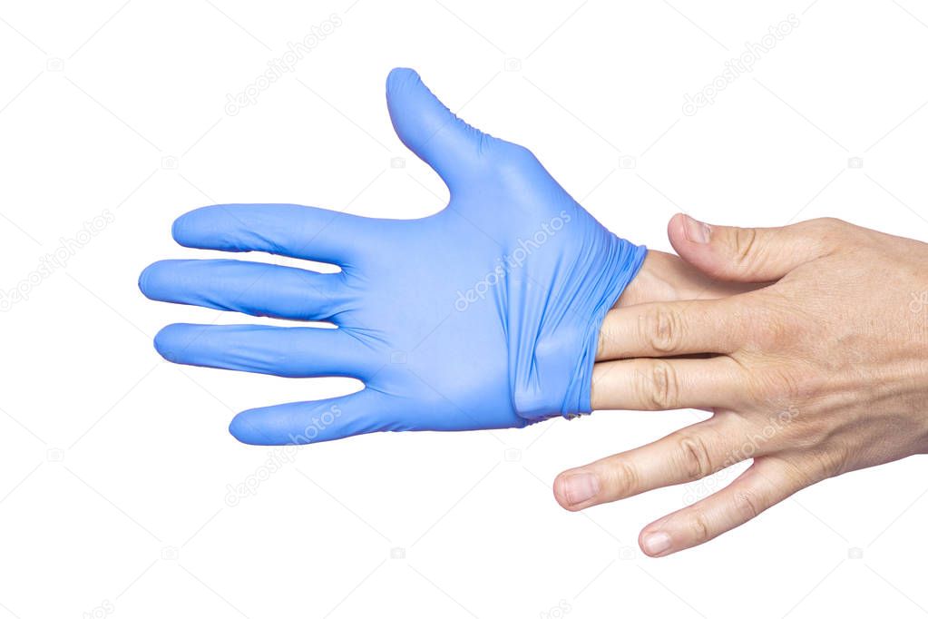 Doctor taking off her blue medical gloves. White background