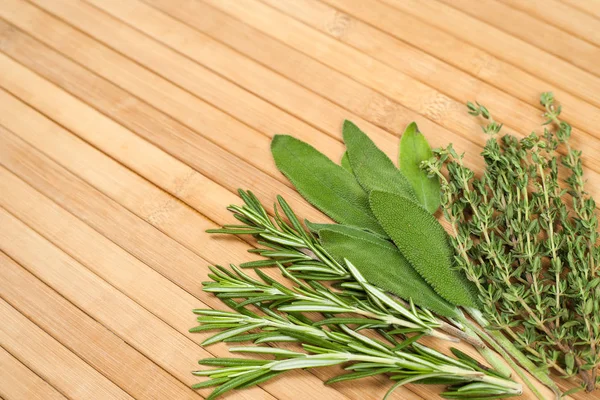 Collection of fresh herbs for cooking isolated on wooden backgro — Stock Photo, Image