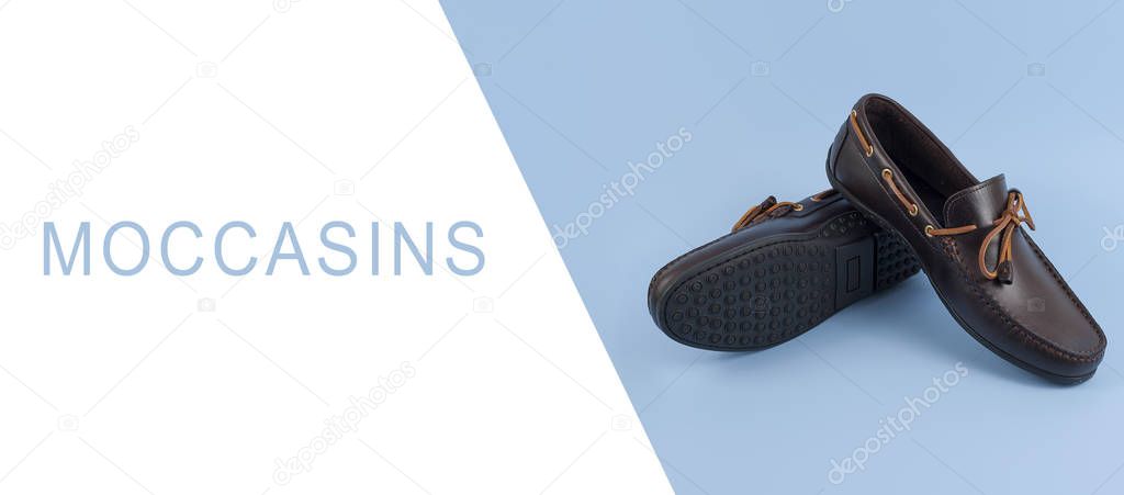 Pair of stylish moccasins on blue background, free space for tex