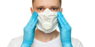 Lateks koruyucu eldivenli genç cerrah beyaz arka plana beyaz koruma maskesi takıyor. Tıbbi eldivenli ve koruyucu maskeli bir adam. Coronavirus COVID-19 koruması