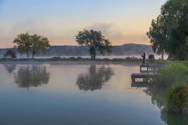 Walk with morning fog on the lake. Fishing at dawn. Kiev region, Ukraine. 20 September 2020