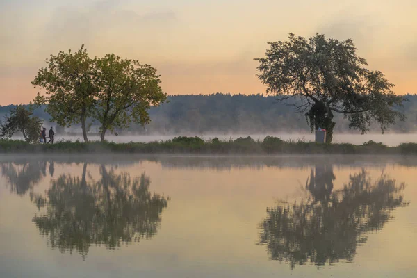 Walk with morning fog on the lake. Fishing at dawn. Kiev region, Ukraine. 20 September 2020