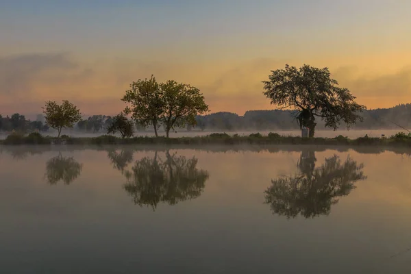 Walk with morning fog on the lake. Fishing at dawn. Kiev region, Ukraine. 20 September 2020