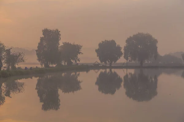 Walk on the lake in the morning fog. Fishing at dawn. Kiev region, Ukraine. September 10, 2020