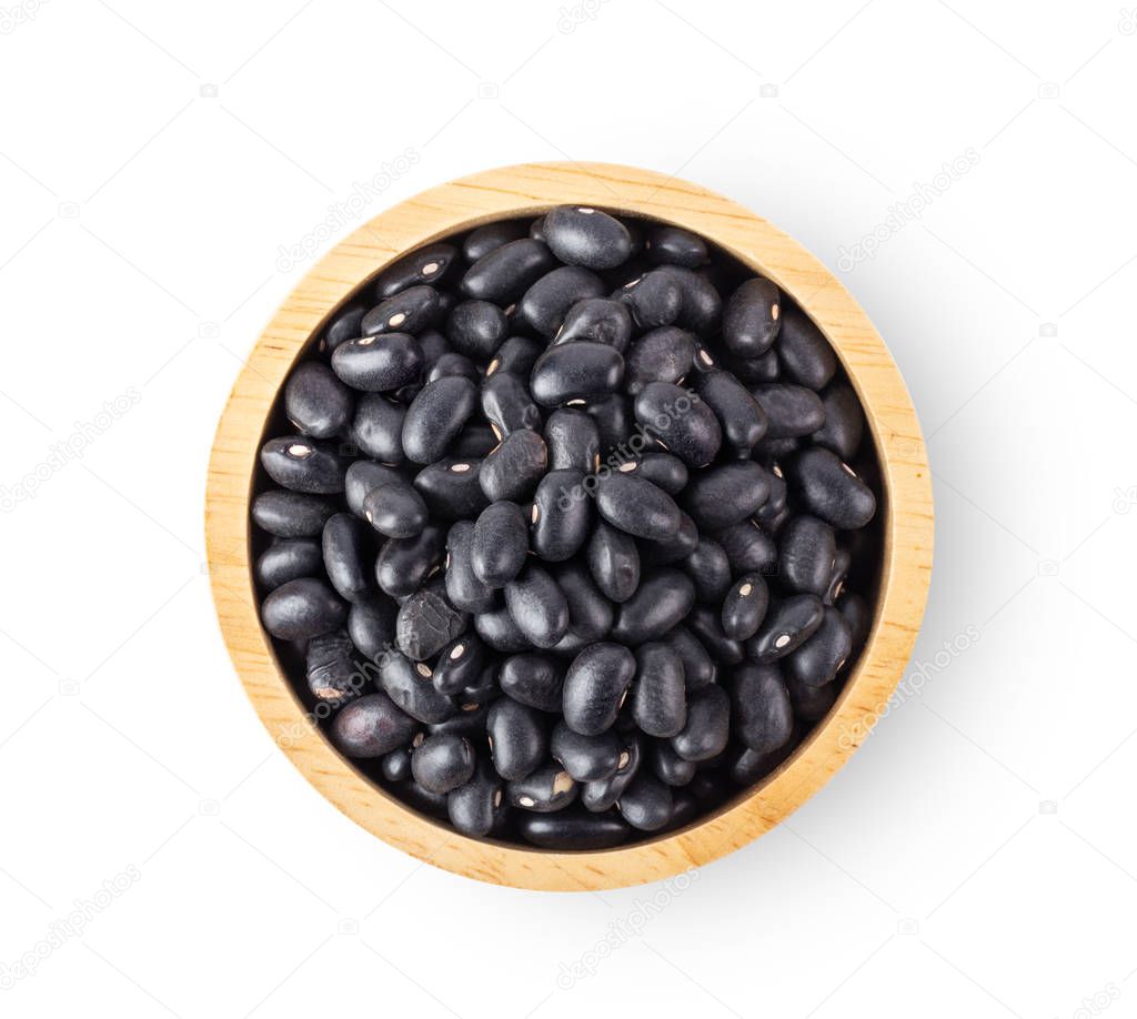 black beans in wood bowl isolated on white background. top view