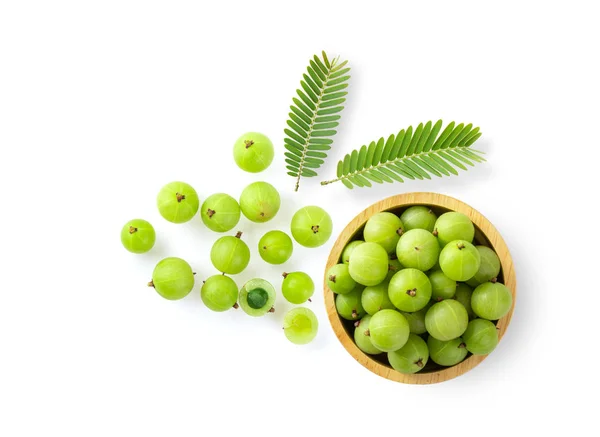 Indian gooseberry in wood bowl on white background. top view