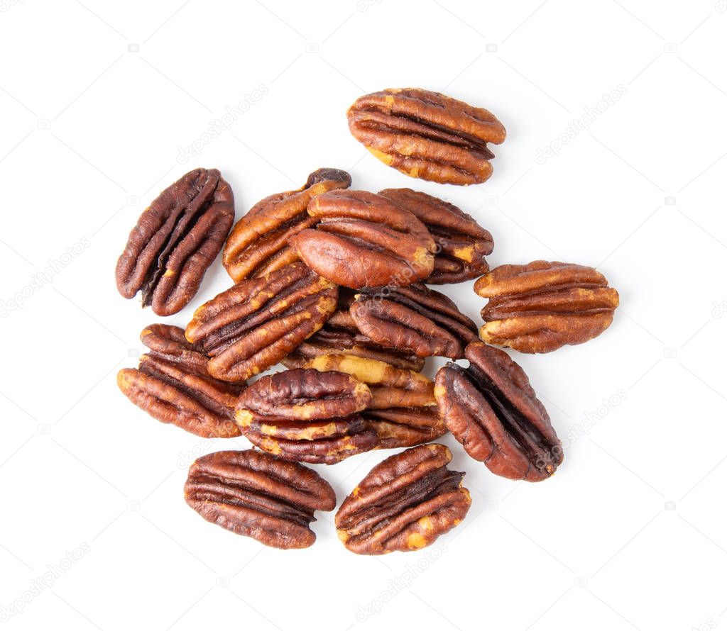Pecan nuts topped with light salt isolated  on white background . top view