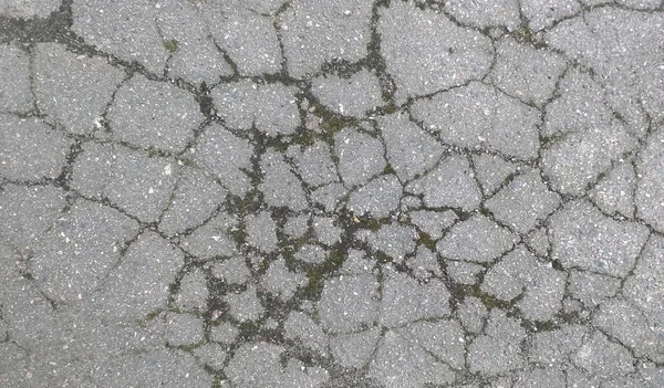 Vecchia consistenza asfaltata. sfondo stradale incrinato — Foto Stock