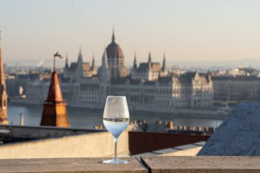 Reflection in wine glass of Hungary Paliament in Budapest winter morning time clipart