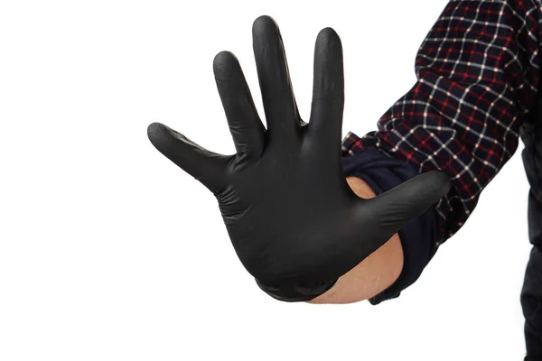 Main masculine en gants de caoutchouc noir, symbole, signe ou geste. Sur fond d'isolat blanc . — Photo