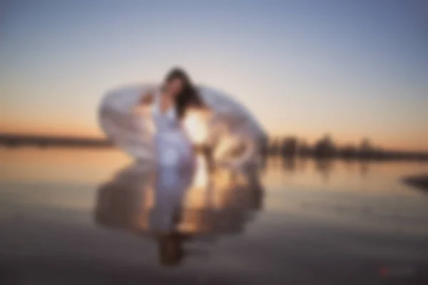 Blurry picture for background, Angel at sunset by the sea,  good idea fantasy.