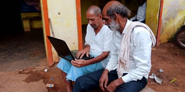 Katni Bölgesi, Madhya Pradesh, Hindistan - 20 Ağustos 2019: İki Hintli köylü geleneksel giysiler giyerek dizüstü bilgisayar teknolojisini öğreniyor.