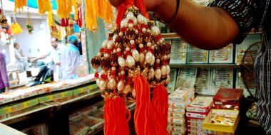 DİSTRİK KATNI, INDIA - 12 AĞUSTOS 2019: Asyalı bir erkek eli, Asya caddesindeki ana markette düzenlenen geleneksel Hint festivali sırasında güzel rakhi sundu.