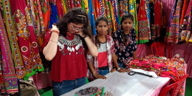 DISTRICT KATNI, INDIA - 22 Eylül 2019: Boyun mücevheri takan Asyalı bir kız, şehir galerisindeki geleneksel giyim mağazasına girdi.