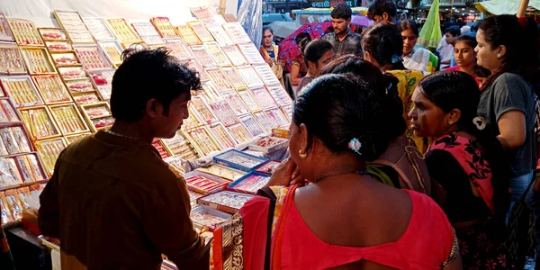 stock image DISTRICT KATNI, INDIA - AUGUST 14, 2019: Asian woman looking for Rakhi buying at hindu religious festival at local street bazaar.