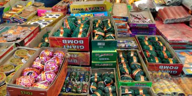 DISTRICT KATNI, INDIA - 15 Ekim 2019: Hindu geleneği Diwali festivali sırasında Hint sokak pazarında satmak için Asyalı satıcı tarafından gösterilen renkli kraker bombası.