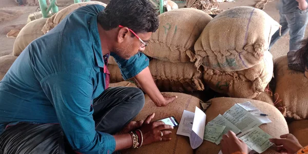 DISTRICT KATNI, INDIA - 18 Eylül 2019: Hint köyü çiftçisi Ham gıda tahıl tarım pazarındaki ekinlerin fiyatını hesaplıyor.