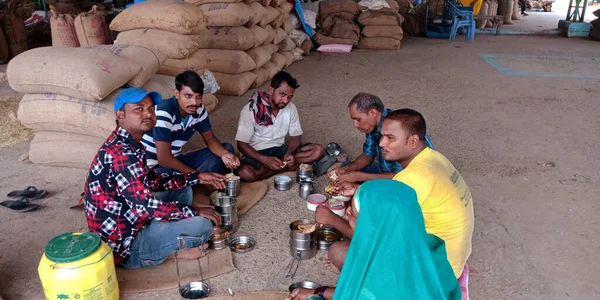 DISTRICT KATNI, INDIA - SEPTEMBER 18, 2019: Indian poor people doing lunch at food corporation of india go down.