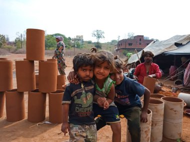 DISTRICT KATNI, INDIA - 21 HAZİRAN 2020: Hintli yoksul çocuklar açık alan atölyesinde Drum oluşturma alanının etrafında toplanıyor.