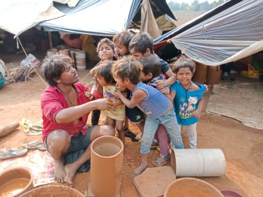 DISTRICT KATNI, INDIA - 21 HAZİRAN 2020: Hintli yoksul çocuklar açık alan atölyesindeki toprak alanında sanatçı mekanında oynuyorlar.