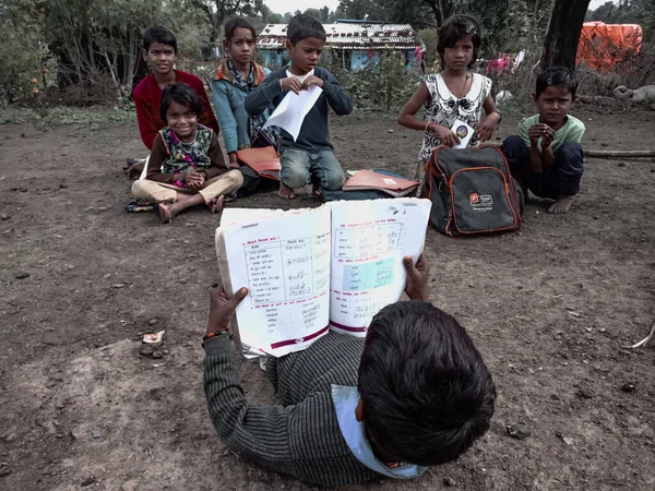 DISTRICT KATNI, INDIA - HAZİRAN 01, 2020: Hintli bir okul çocuğu köy açık hava ortamında Hintçe orta öğretim kitabı okuyor.