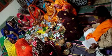 DISTRICT KATNI, INDIA - SEPTEMBER 12, 2019: Indian traditional women group circle worshiping together on religious fast called Teej pooja in hindi. clipart