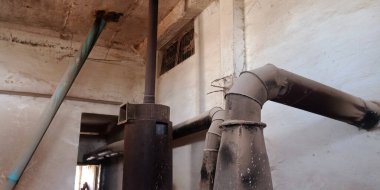 Paslı arka plana maruz bırakılmış eski bir pirinç değirmeni makinesi..