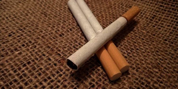 Three White Cigarette Brown Sack Mat Background Pack Cigarettes Close — Stock Photo, Image