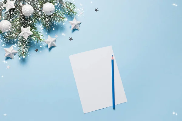 Christmas background. Xmas checklist or empty blank letter for Santa Claus on blue. New year card. Flat lay.