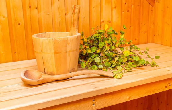 Sauna interior details - wooden bucket and birch twigs