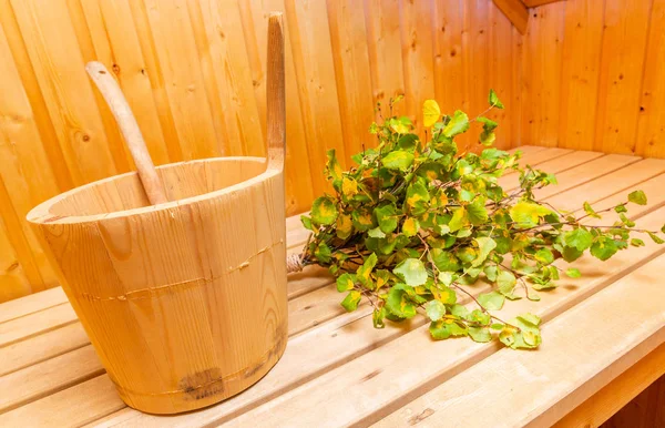 Sauna interior details - wooden bucket and birch twigs