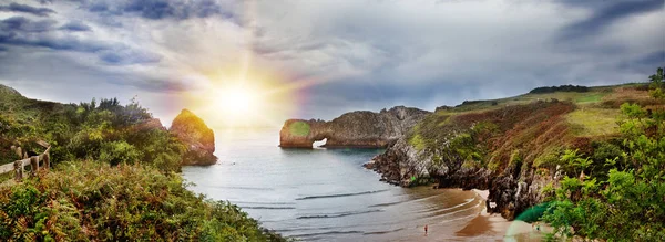 Beautiful landscape of beach and coast with mountains and vegetation. Impressive scene of coast and cliffs in Cantabria, Spain.Beach of Bellern.