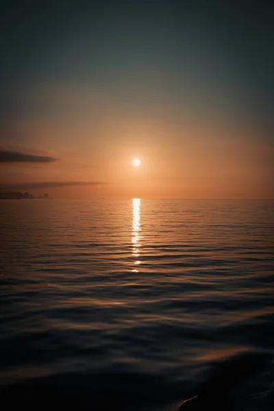 A super relaxing view of the horizon of the ocean with the sunset reflecting over the surface