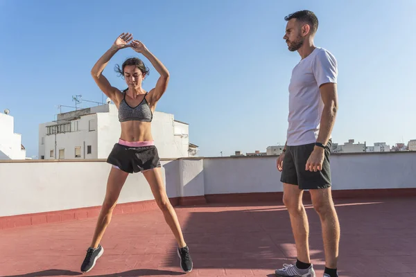 Athletic Young Woman Doing Jumping Jack Exercise While Being Supervised — Stock Photo, Image