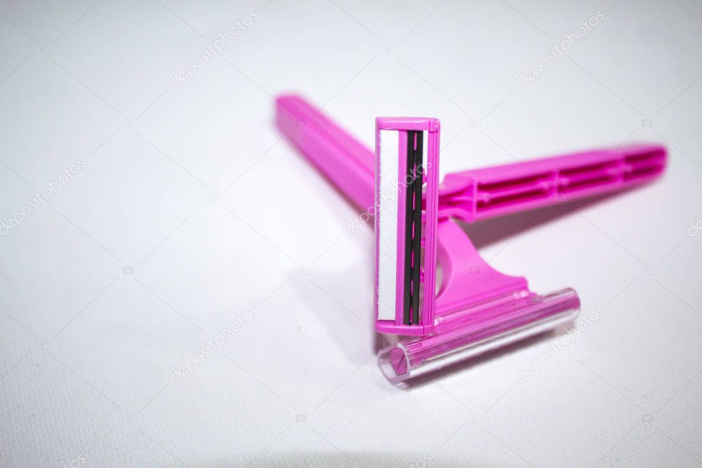 pink razor on a white background