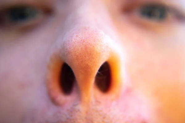 face with human nose closeup