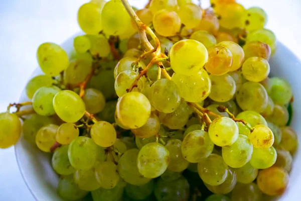 white grapes on the plate, white background