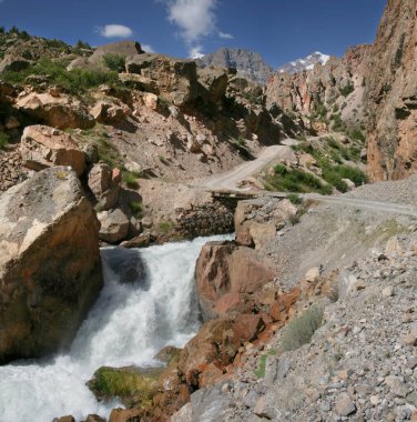 Pamirlerin, Tacikistan 'ın dağlarındaki yol. Fırtınalı nehrin üzerindeki köprü. Orta Asya 'da Seyahat.
