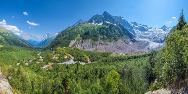 Panoramic view of a picturesque mountain valley. Summer greens and glaciers. North Caucasus, Russia.	