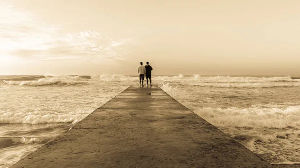 Father Son Fishing Silhouetted Unidentified Beach Jetty Waters Edge Ocean — Stock Photo, Image