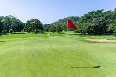 Golf course hole flagstick green scenic summer coastal course clipart